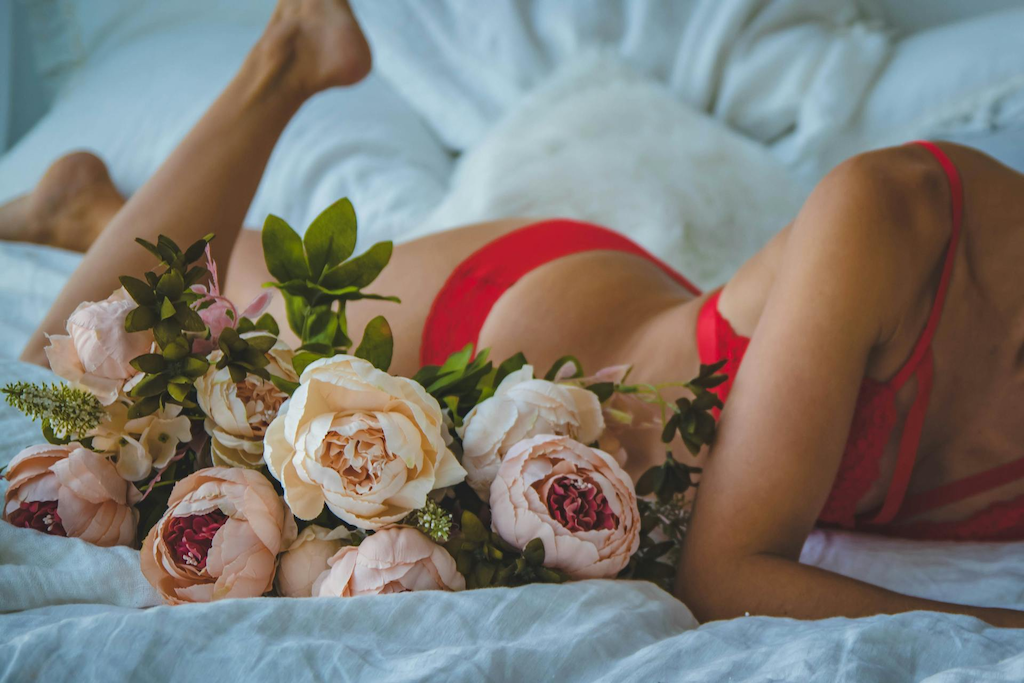 woman-in-red-lingerie-in-bed-solo-with-flowers
